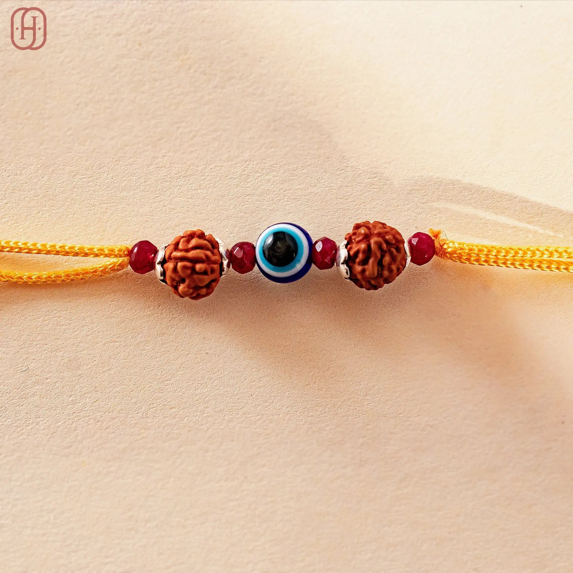 Hardik Jewels Rudraksha Evil Eye Rakhi with 92.5 Silver Beads.