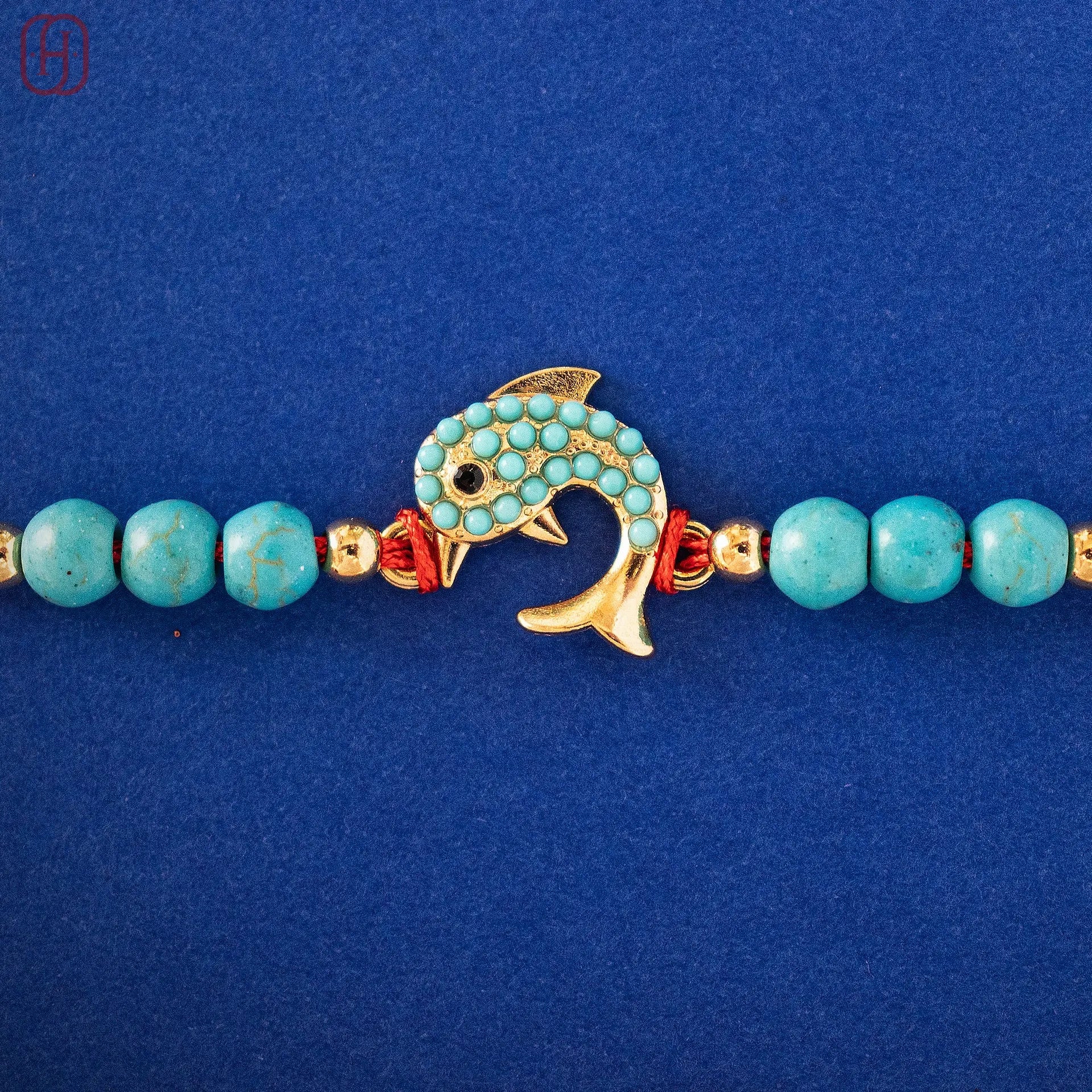 Hardik Jewels Silver Fish Rakhi with Turquoise Beads.