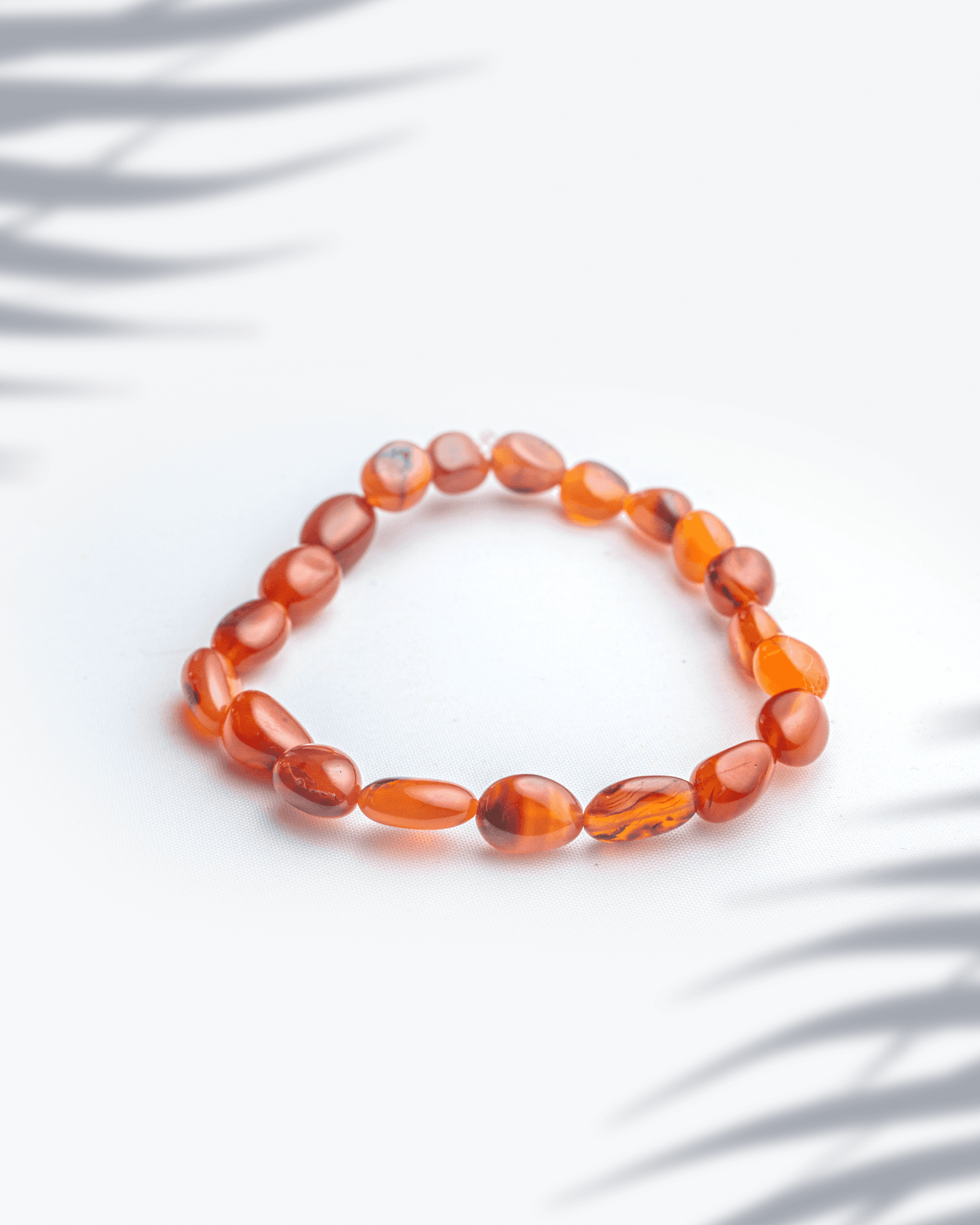 Natural carnelian gemstone bracelet featuring organic oval shaped orange beads.