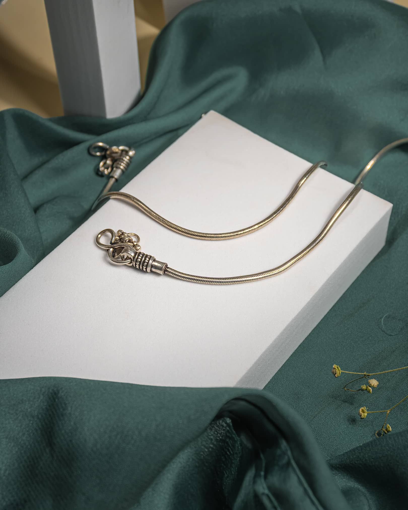 Pair of sturdy 925 sterling silver snake chain anklets with oxidized end caps and S-hook closure on a beige background.