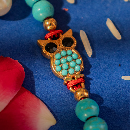 Hardik Jewels Handcrafted Owl Silver Rakhi with Turquoise Beads.