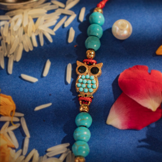 Hardik Jewels Handcrafted Owl Silver Rakhi with Turquoise Beads.
