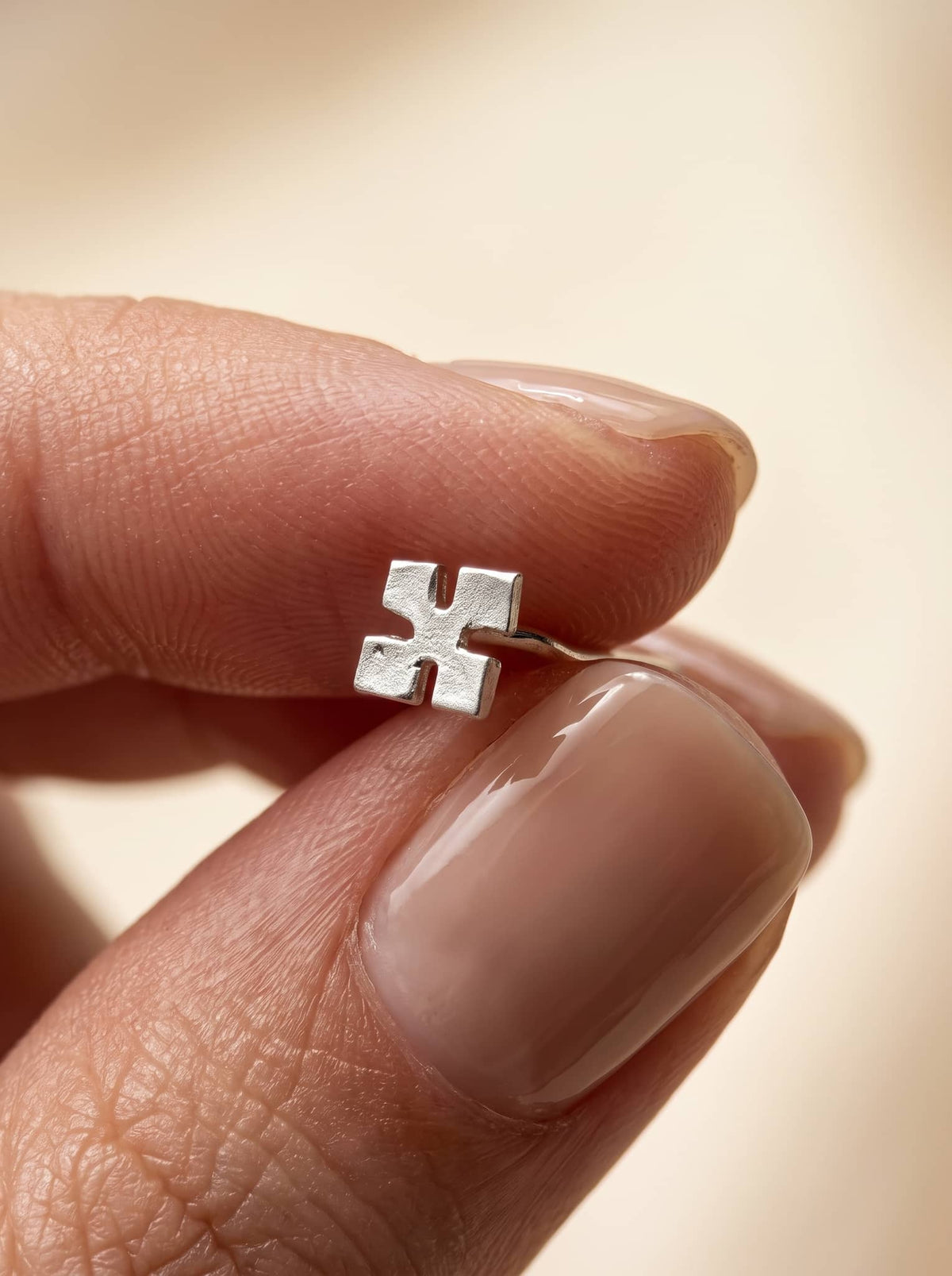 Minimal Cross Silver Stud Earrings - close-up detail view - Hardik Jewels