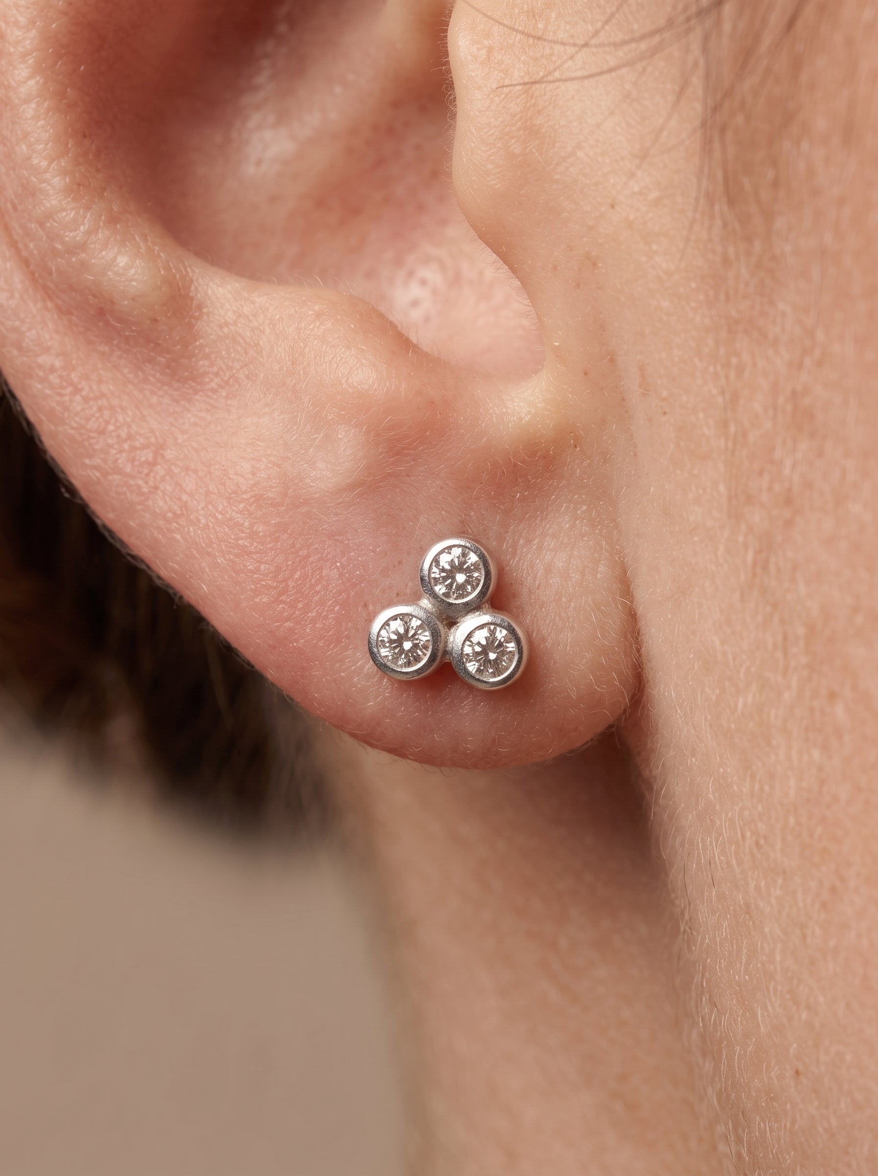 Triple CZ Cluster Silver Stud Earrings - ear styling view - Hardik Jewels