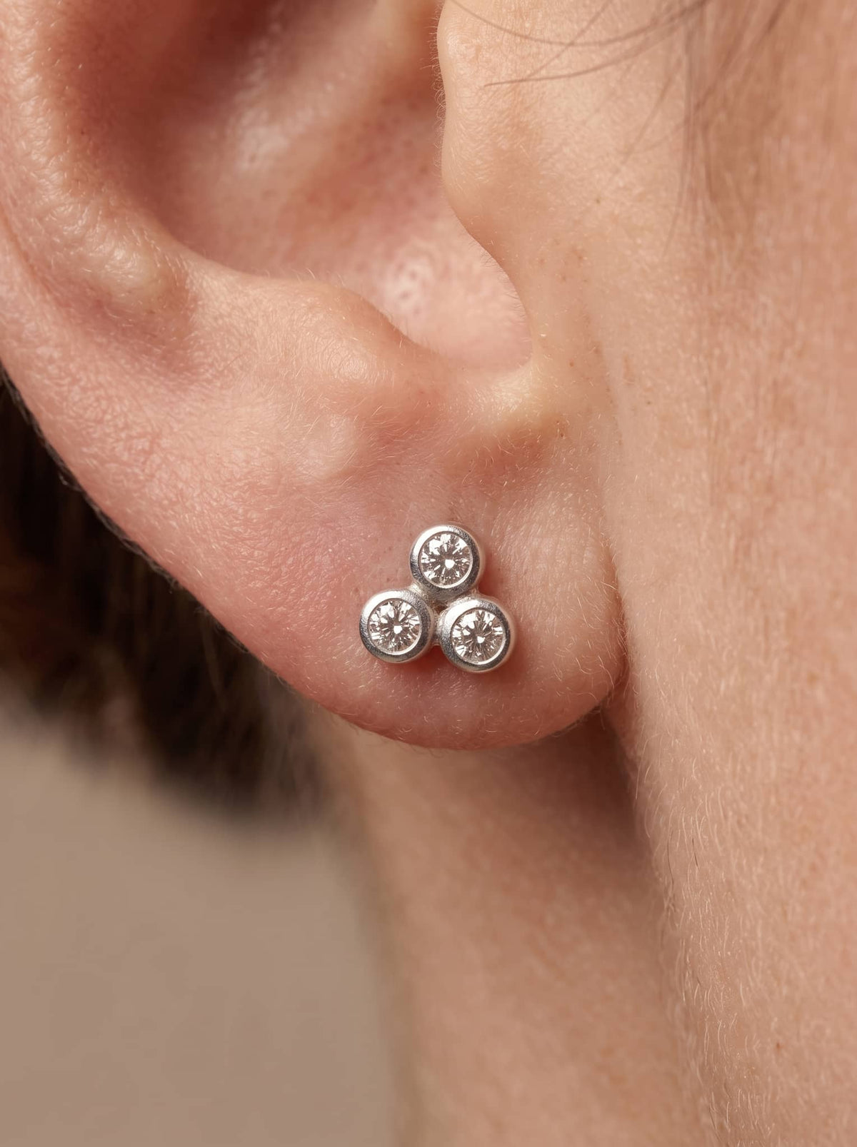 Triple CZ Cluster Silver Stud Earrings - ear styling view - Hardik Jewels