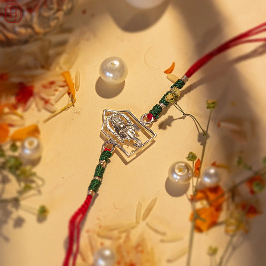 Ganesh Ji face rakhi online with silver charm and red green thread by Hardik Jewels
