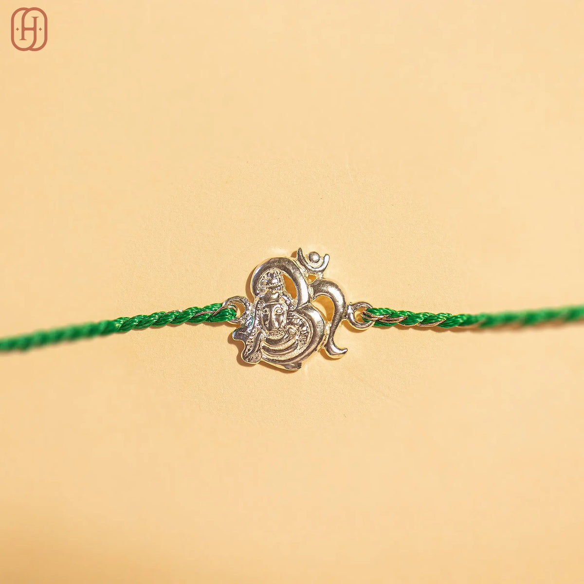 92.5 silver rakhi for brother with Lord Ganesha charm and green thread by Hardik Jewels