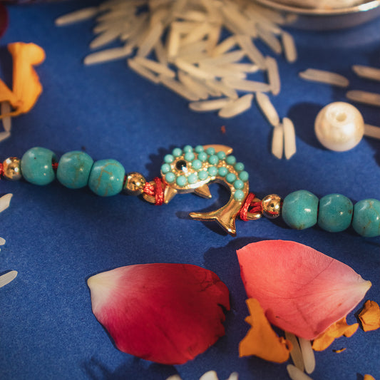 Hardik Jewels Silver Fish Rakhi with Turquoise Beads.