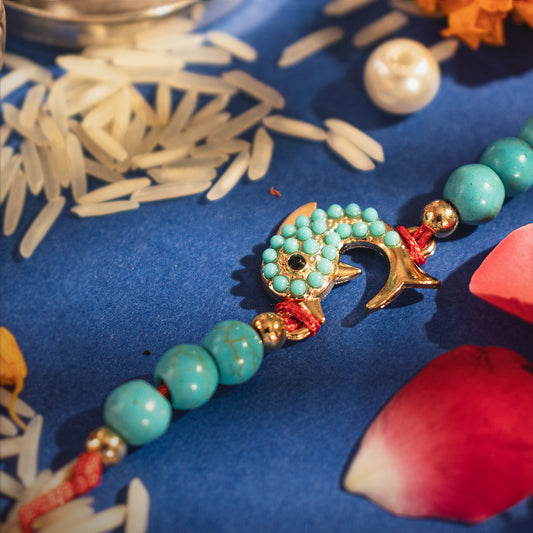 Hardik Jewels Silver Fish Rakhi with Turquoise Beads.