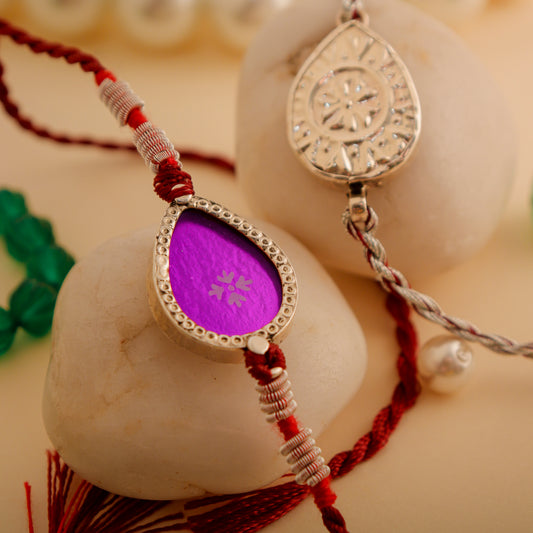 Hardik Jewels Teardrop Rakhi Design with Silver Charm.