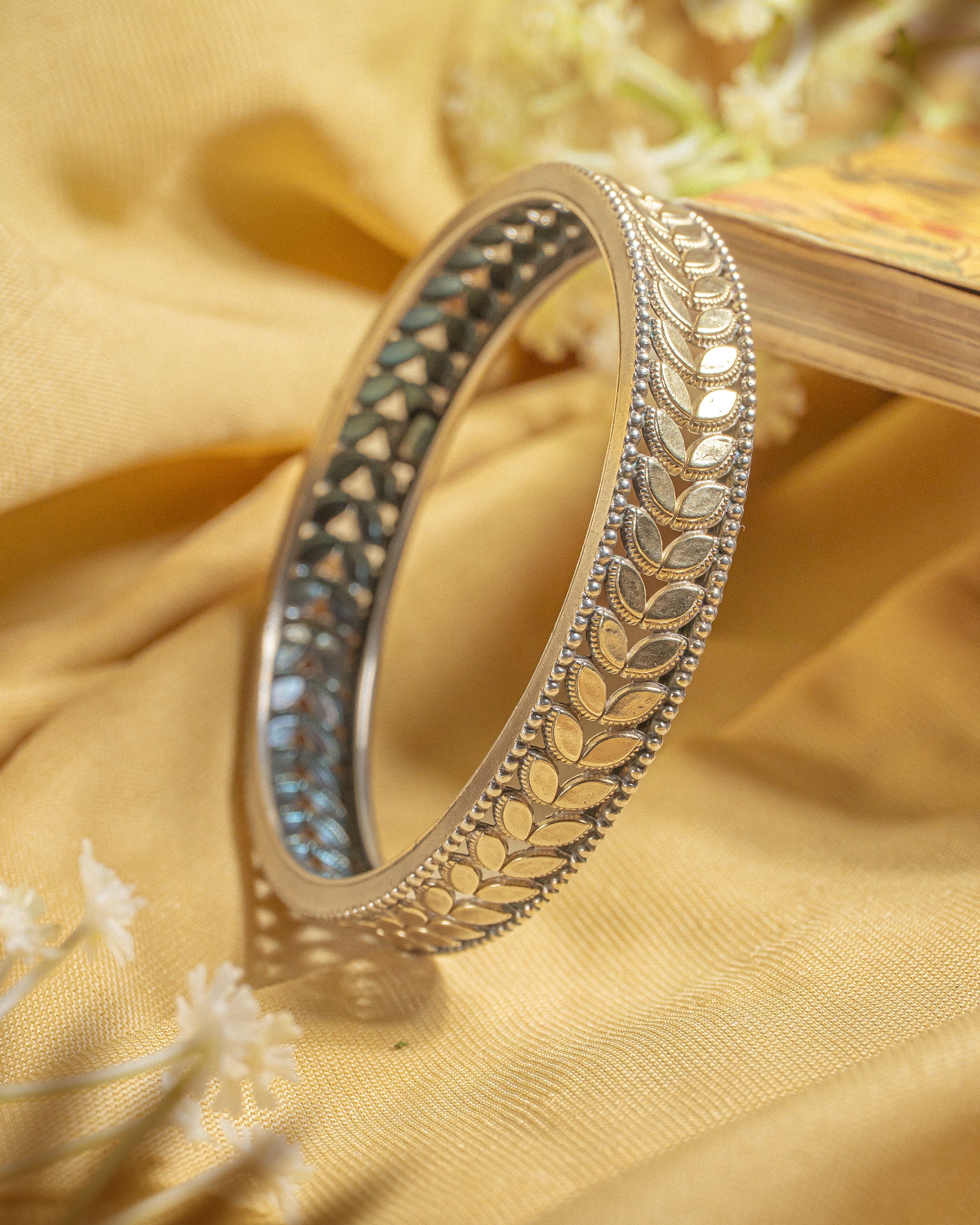 92.5 sterling silver antique bangle featuring oxidized leaf pattern and beaded borders.