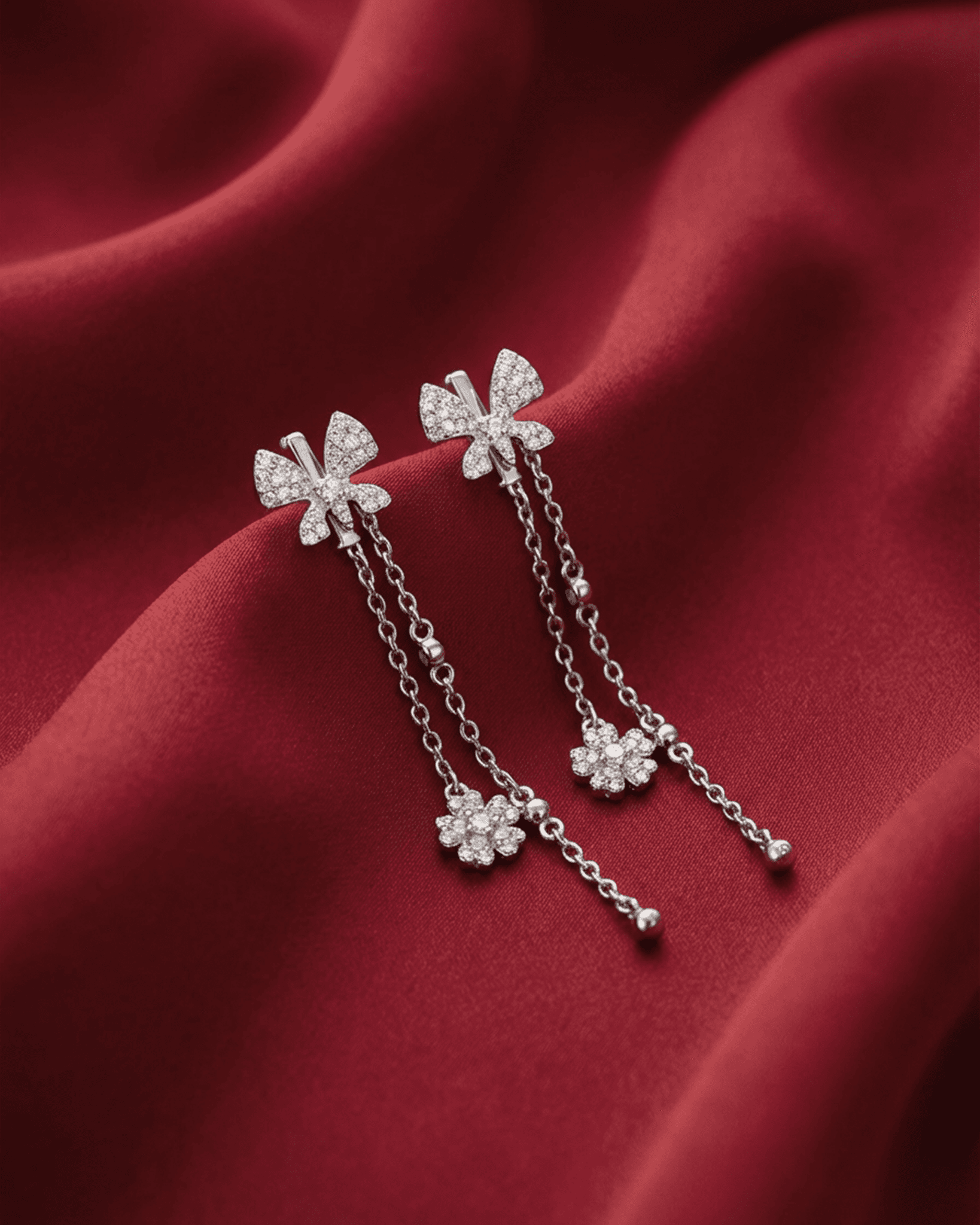 92.5 sterling silver drop earrings featuring cz studded interlocked loops and double pearl drops.