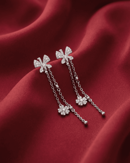 92.5 sterling silver drop earrings featuring cz studded interlocked loops and double pearl drops.