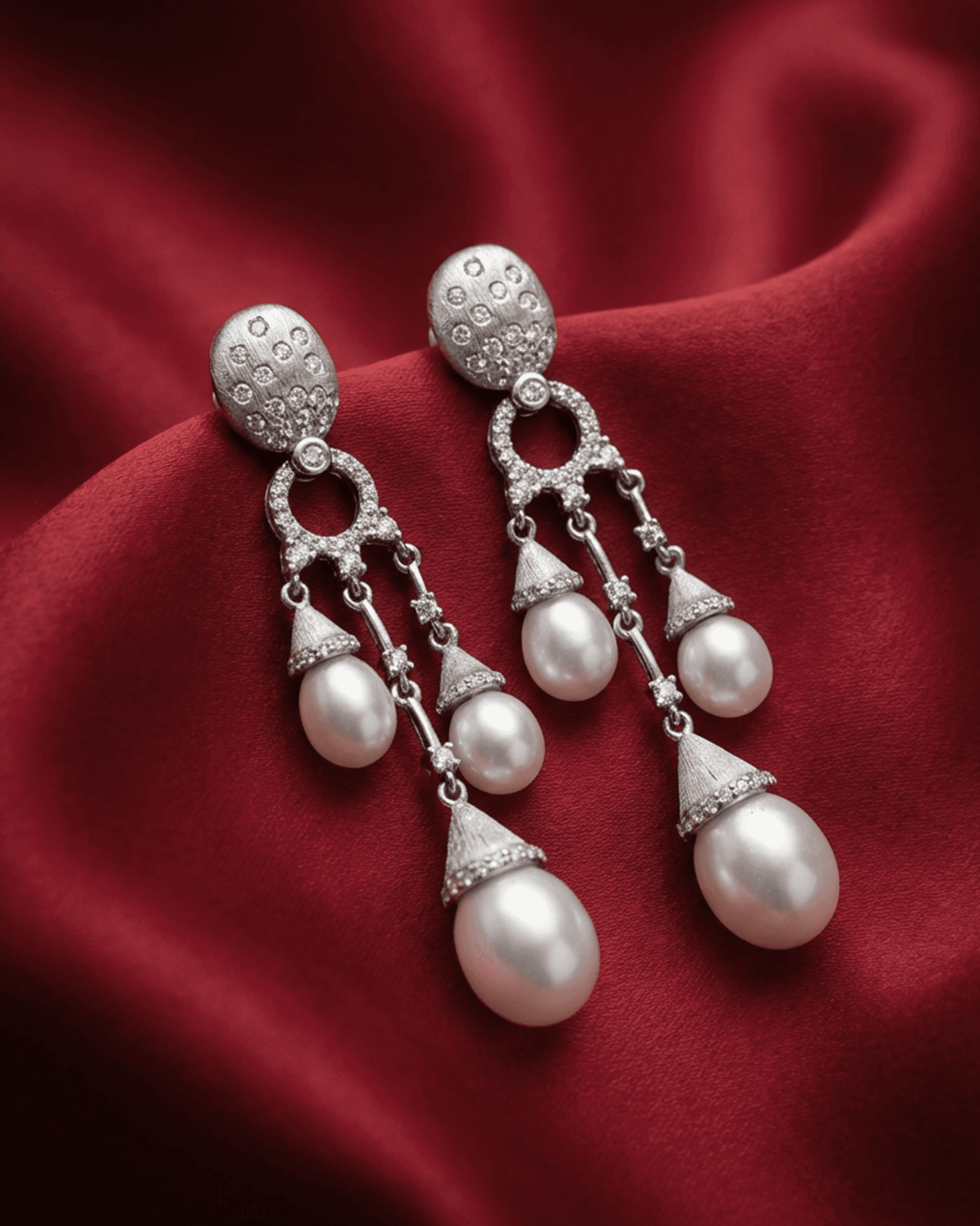 92.5 sterling silver drop earrings featuring triple pearls and matte finish cz studded top.
