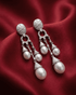92.5 sterling silver drop earrings featuring triple pearls and matte finish cz studded top.