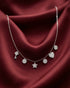 92.5 sterling silver necklace featuring dangling key star heart and disc charms studded with diamonds.