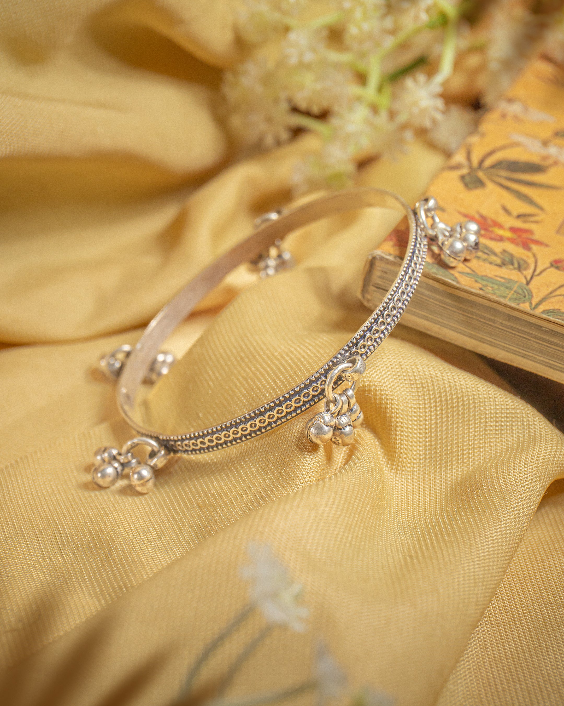 92.5 sterling silver oxidized bangle featuring dangling ghungroo bells for a tribal look.