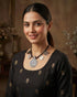 92.5 sterling silver tribal necklace featuring antique coins and a geometric pendant on black braided thread.