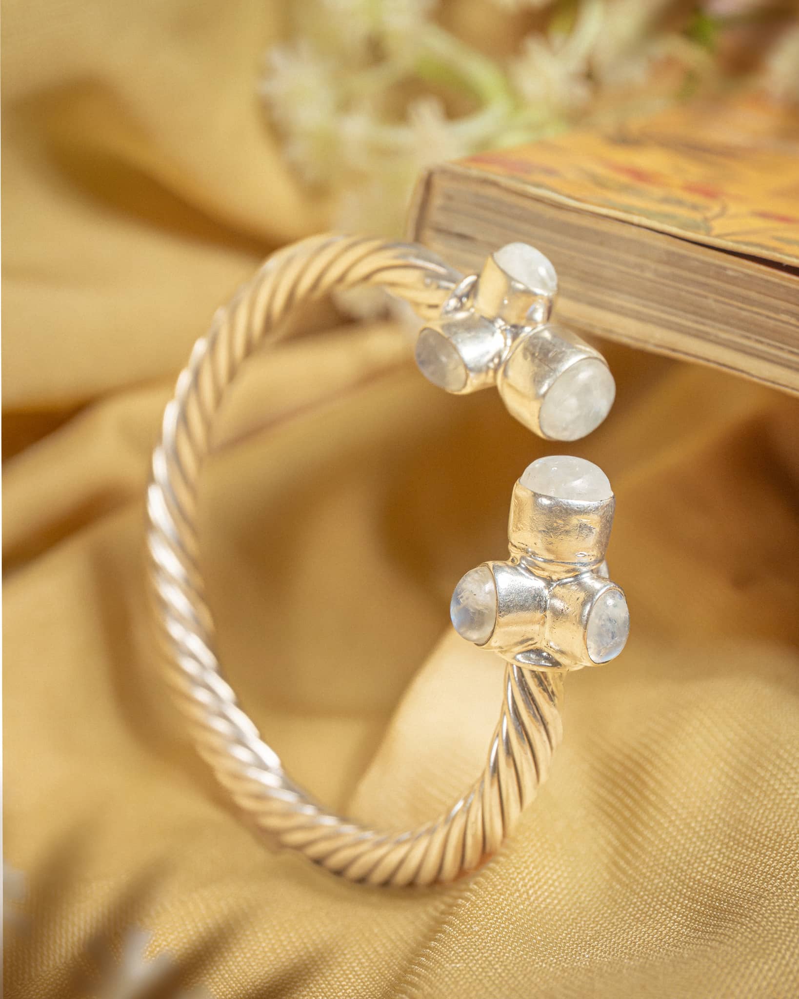 92.5 sterling silver twisted rope cuff bangle featuring triple moonstone clusters at the ends.