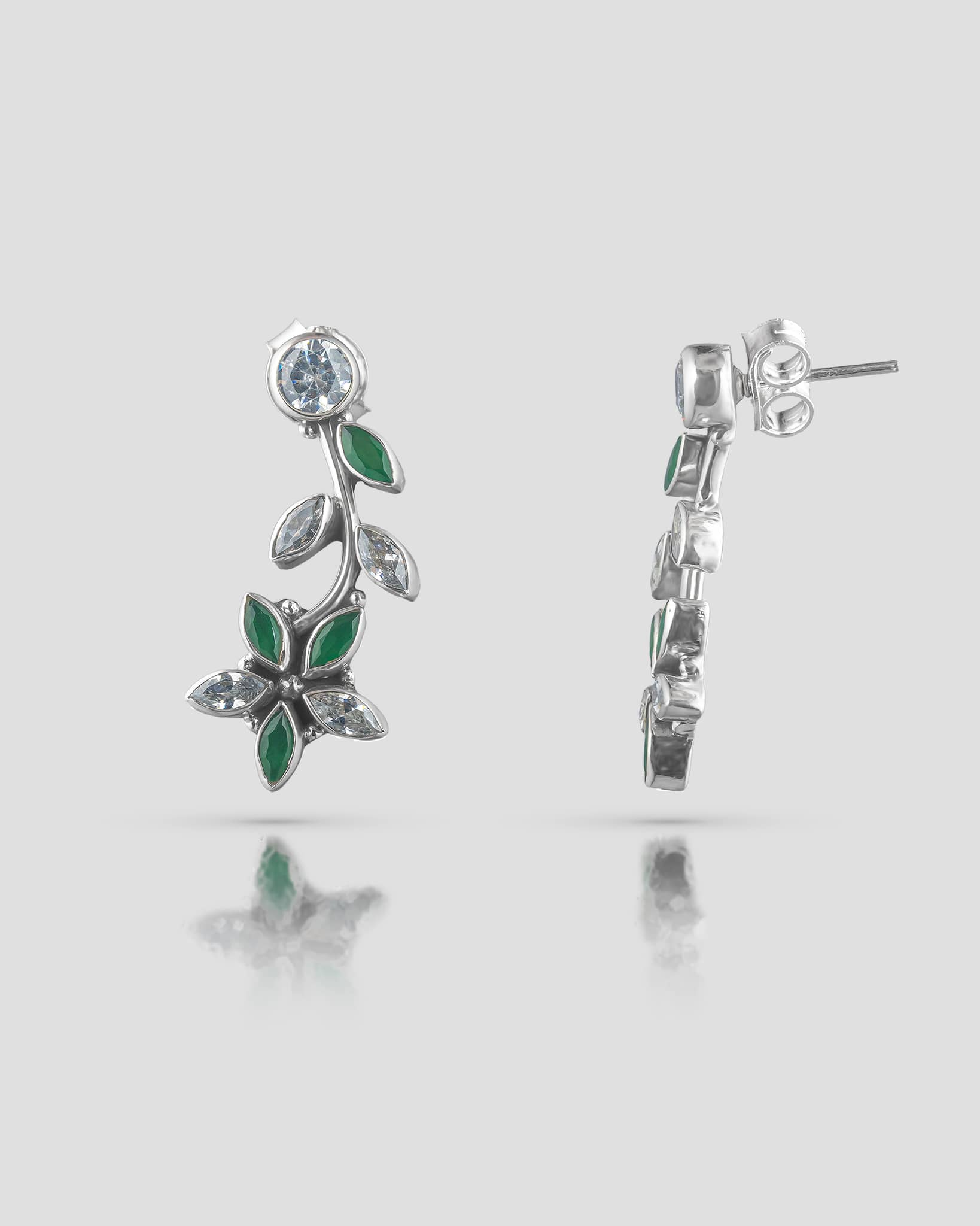 Front and side profile view of silver floral vine drop earrings showcasing a round clear cz top stud, green and clear marquise cz leaves, and push-back closure.