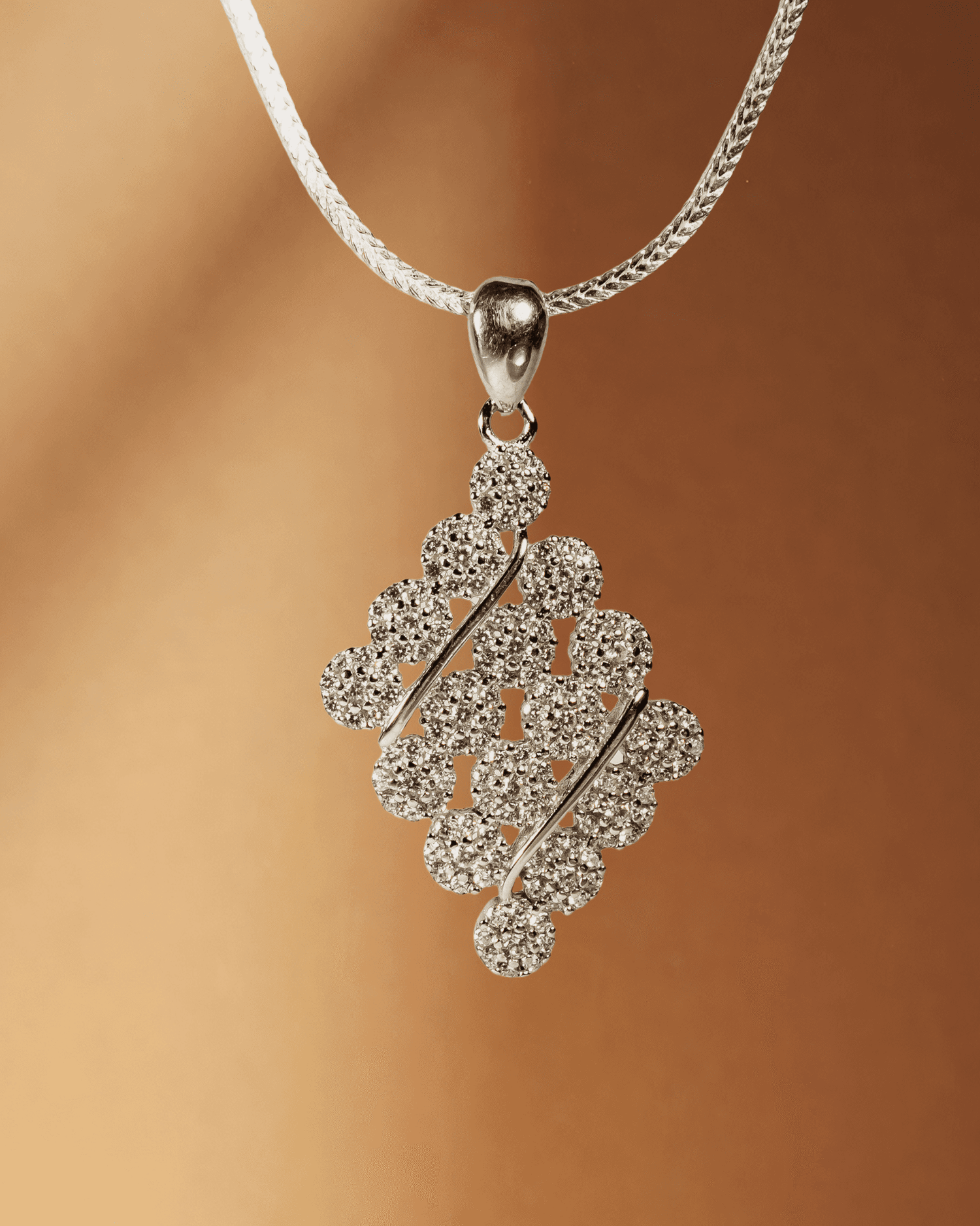 925 sterling silver diamond-shaped cluster pendant and earring set studded with cubic zirconia stones (chain not included).