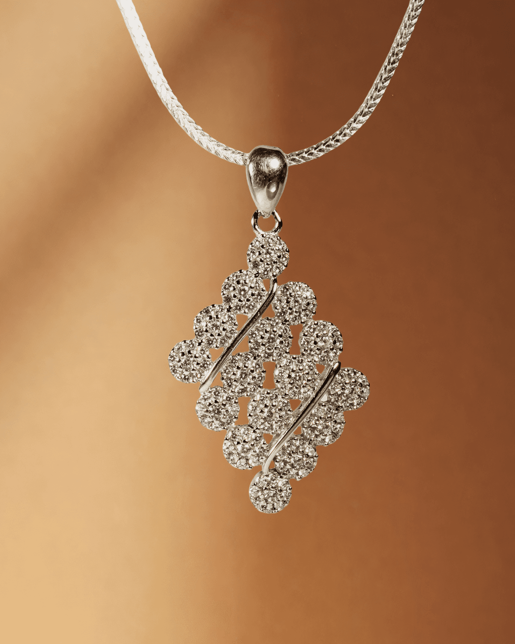925 sterling silver diamond-shaped cluster pendant and earring set studded with cubic zirconia stones (chain not included).
