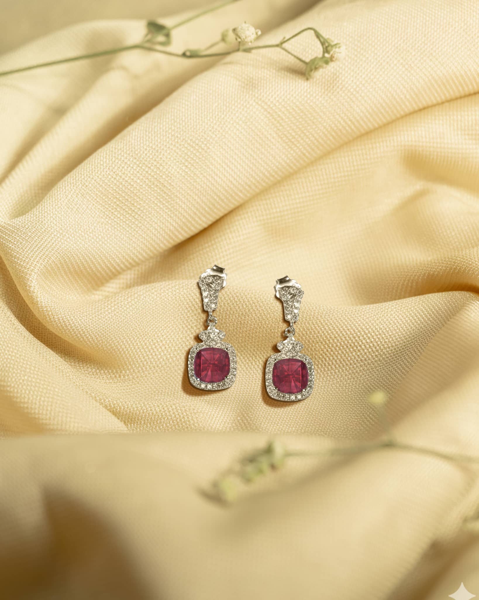 925 sterling silver drop earrings featuring a square cushion-cut ruby red stone surrounded by a white american diamond halo.