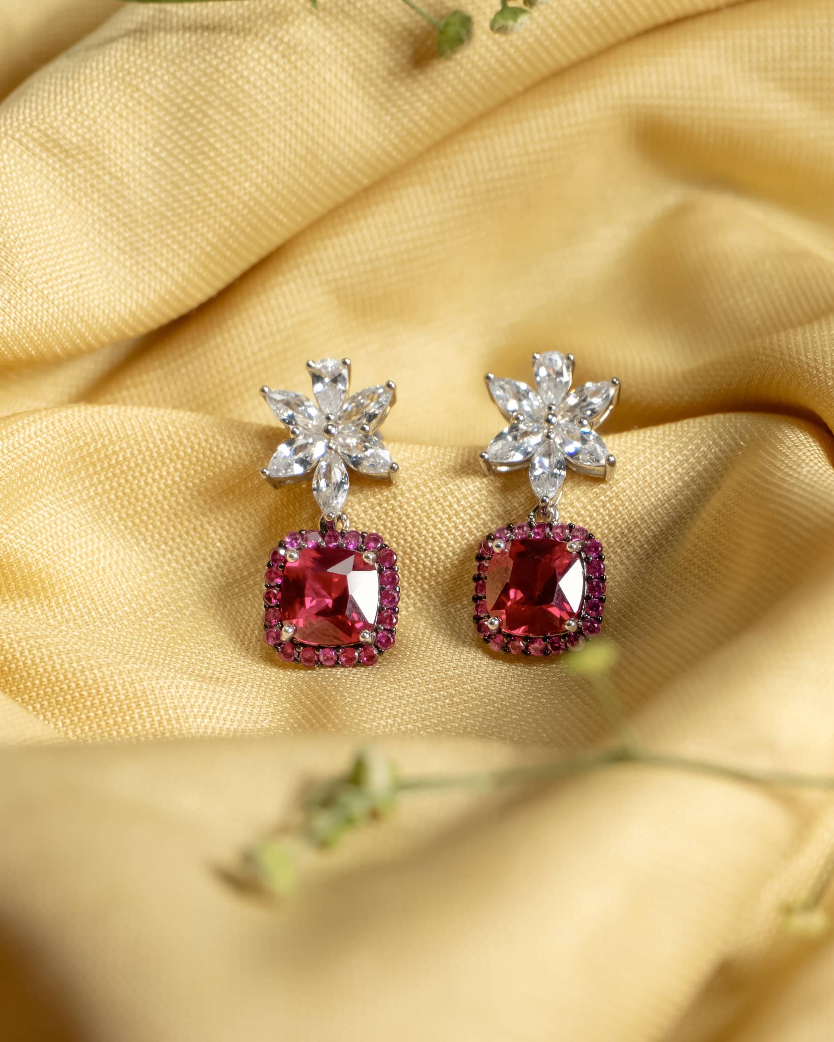 925 sterling silver drop earrings featuring a white marquise floral stud and a ruby red cushion stone with pink halo.
