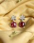 925 sterling silver drop earrings featuring a white marquise floral stud and a ruby red cushion stone with pink halo.