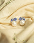 925 sterling silver drop earrings featuring an irregular baroque pearl hanging from a geometric blue stone stud.
