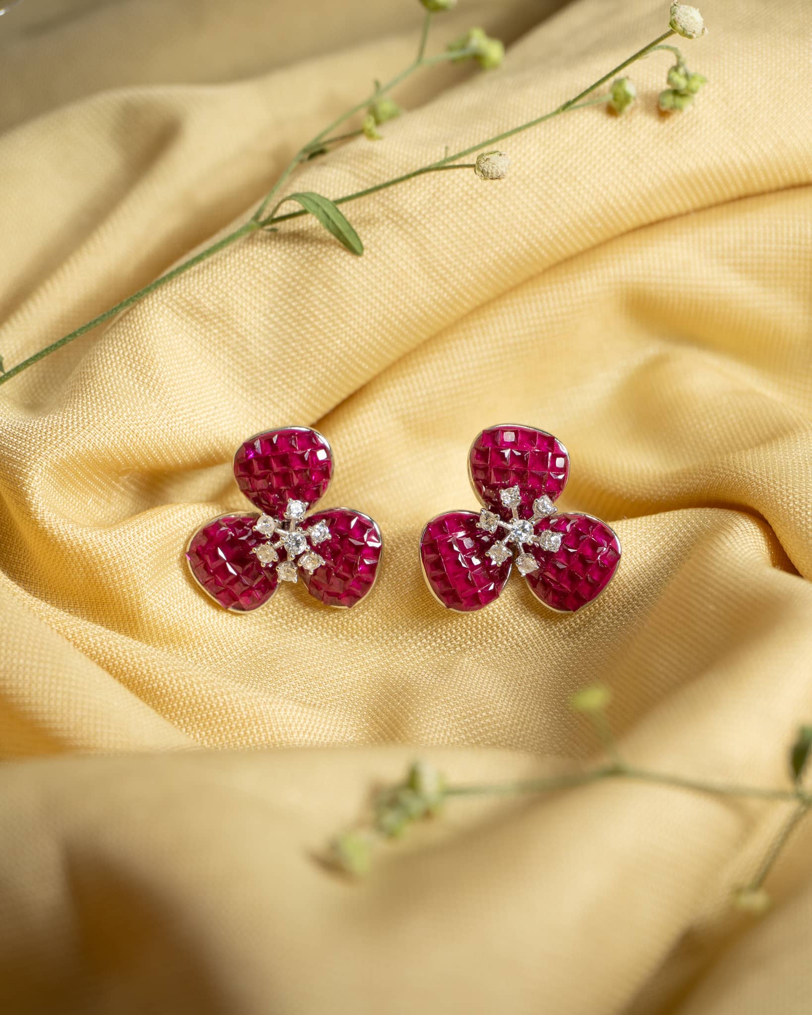 925 sterling silver floral stud earrings featuring invisible set ruby petals and white diamond center.