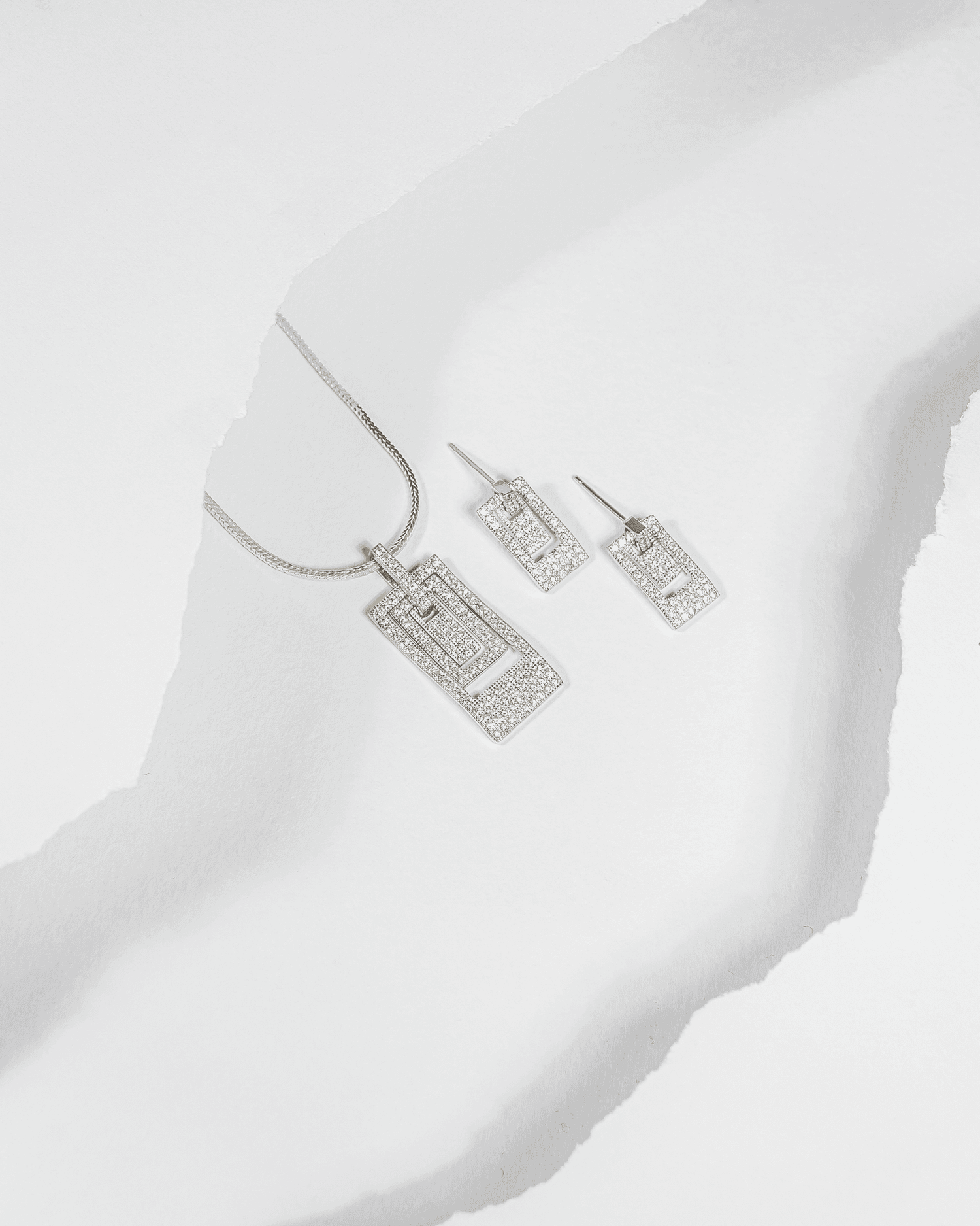 925 sterling silver geometric rectangular pendant and earring set studded with cubic zirconia stones (chain not included).