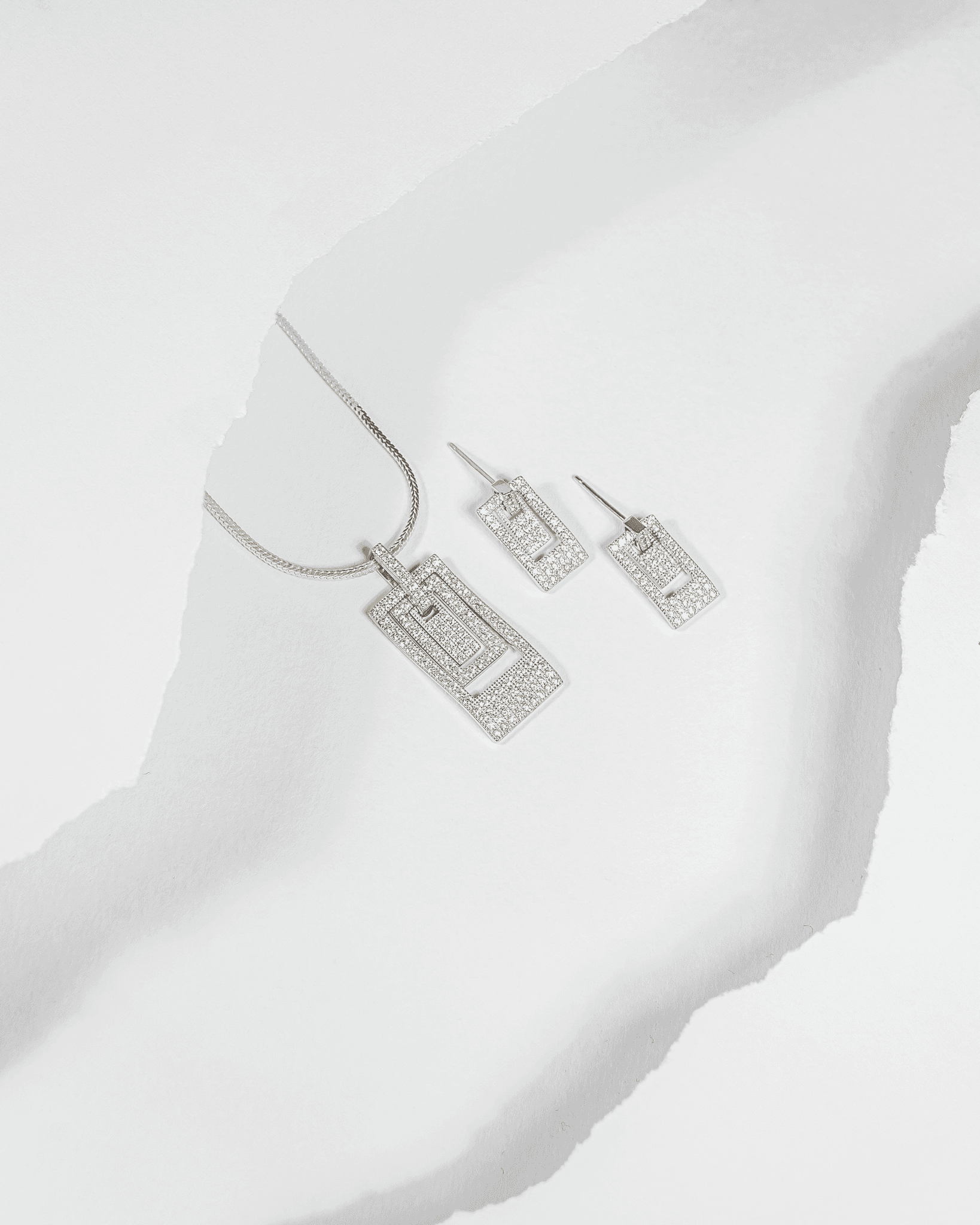 925 sterling silver geometric rectangular pendant and earring set studded with cubic zirconia stones (chain not included).