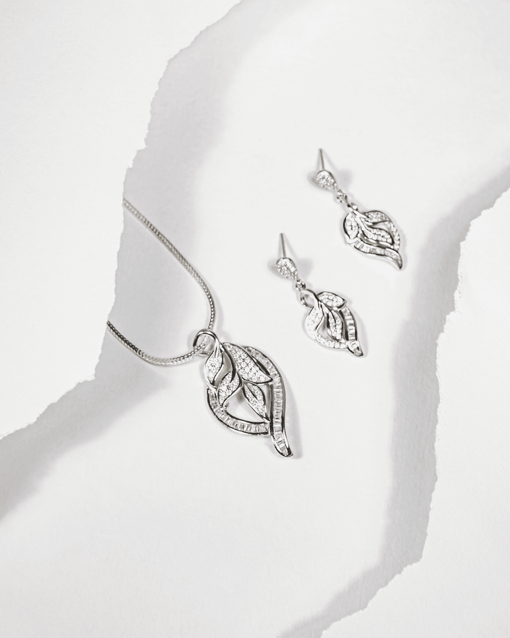 925 sterling silver leaf-shaped pendant and earring set studded with cubic zirconia stones (chain not included).