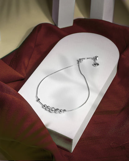 Adjustable 925 sterling silver slider anklet (payal) with textured beads and hanging heart charms.