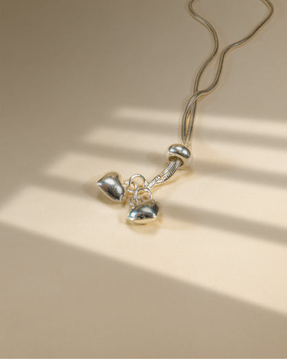 Adjustable 925 sterling silver slider anklet (payal) with textured beads and hanging heart charms.