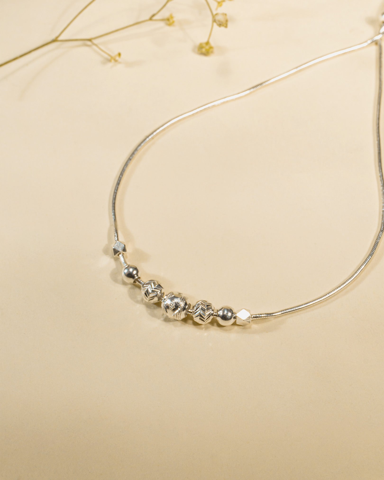 Adjustable 925 sterling silver slider anklet (payal) with textured beads and hanging heart charms.