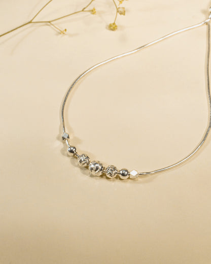 Adjustable 925 sterling silver slider anklet (payal) with textured beads and hanging heart charms.