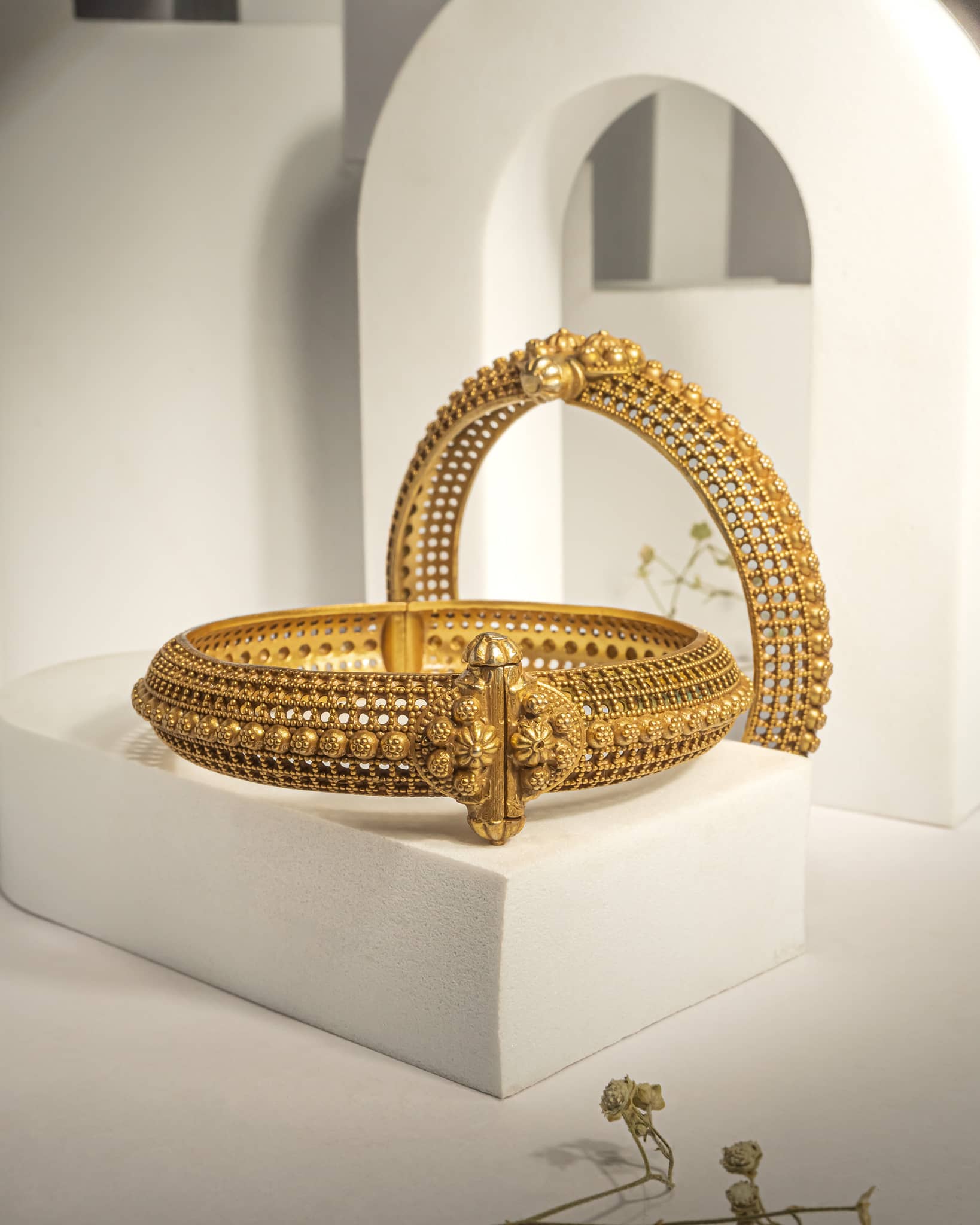 Broad gold plated sterling silver kada featuring intricate jali filigree work and screw openable mechanism.