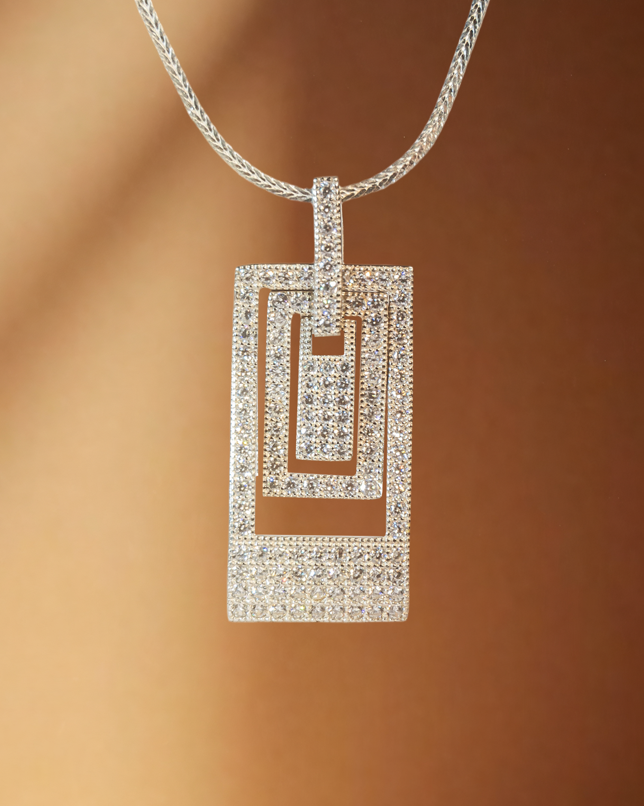 Cubic Zirconia (CZ) pendant necklace on a brown background