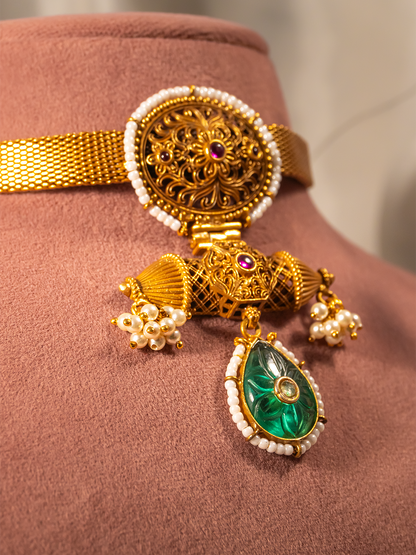 Carved green drop pendant close-up on gold-plated silver choker by Hardik Jewels