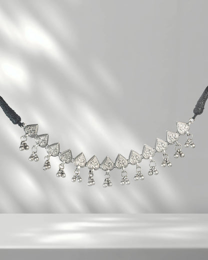 Delicate necklace with heart-shaped pendants on a gray background
