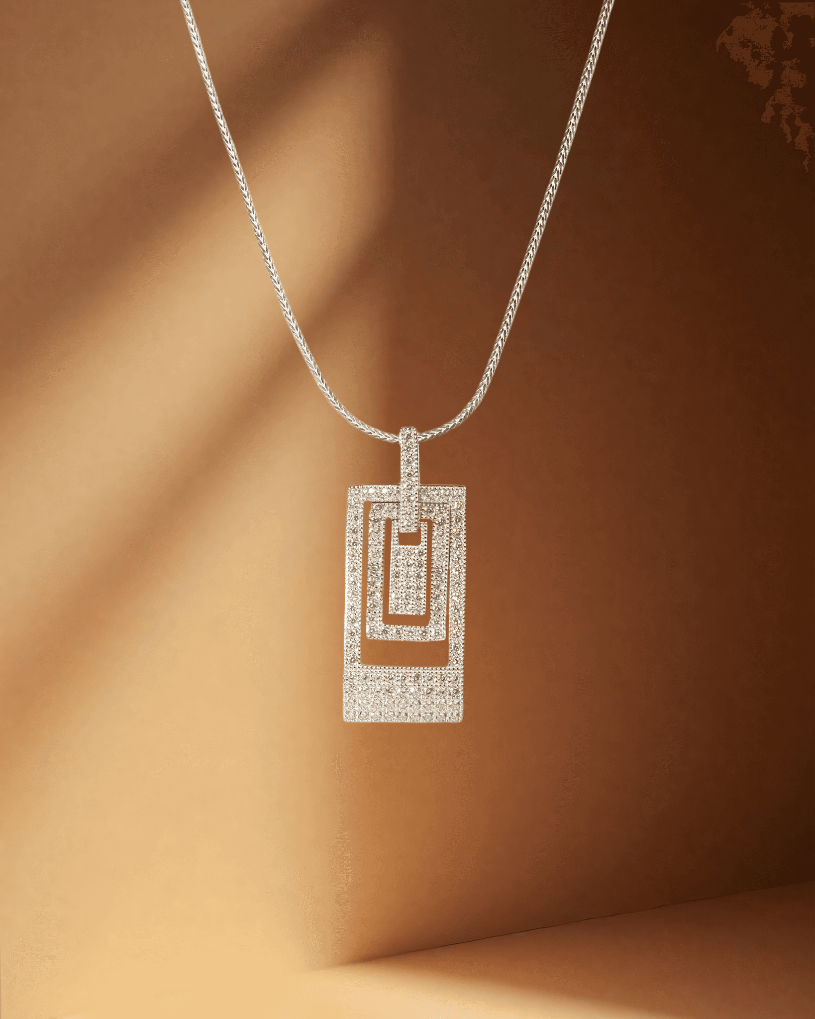Diamond pendant necklace on a brown background
