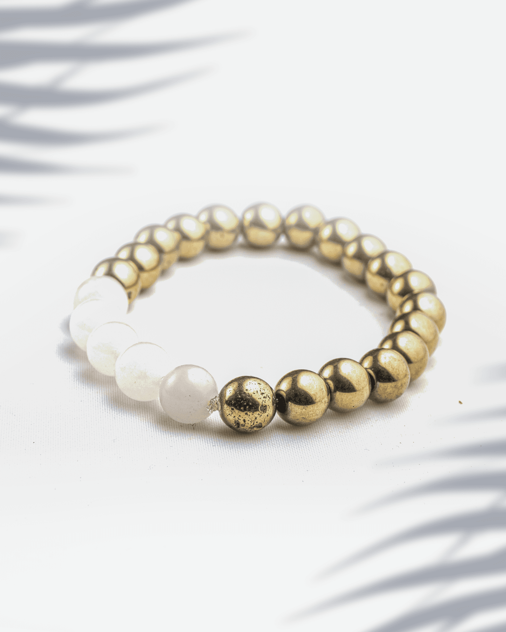 Dual gemstone bracelet featuring metallic golden pyrite beads mixed with soft pink rose quartz beads.