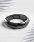 Glossy black rectangular tile fashion bracelet on a white background.