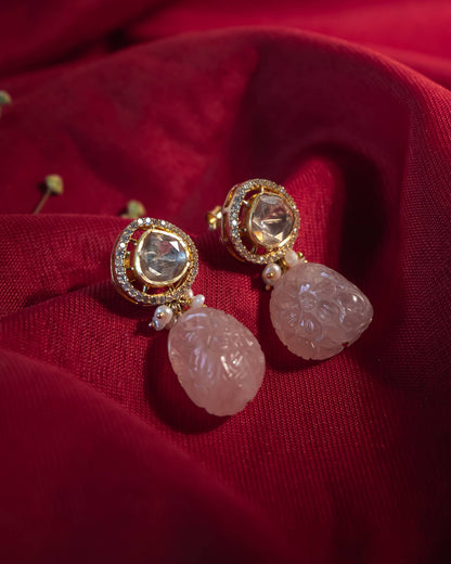 Gold plated 925 silver drop earrings featuring a carved natural rose quartz stone hanging from a polki stud.