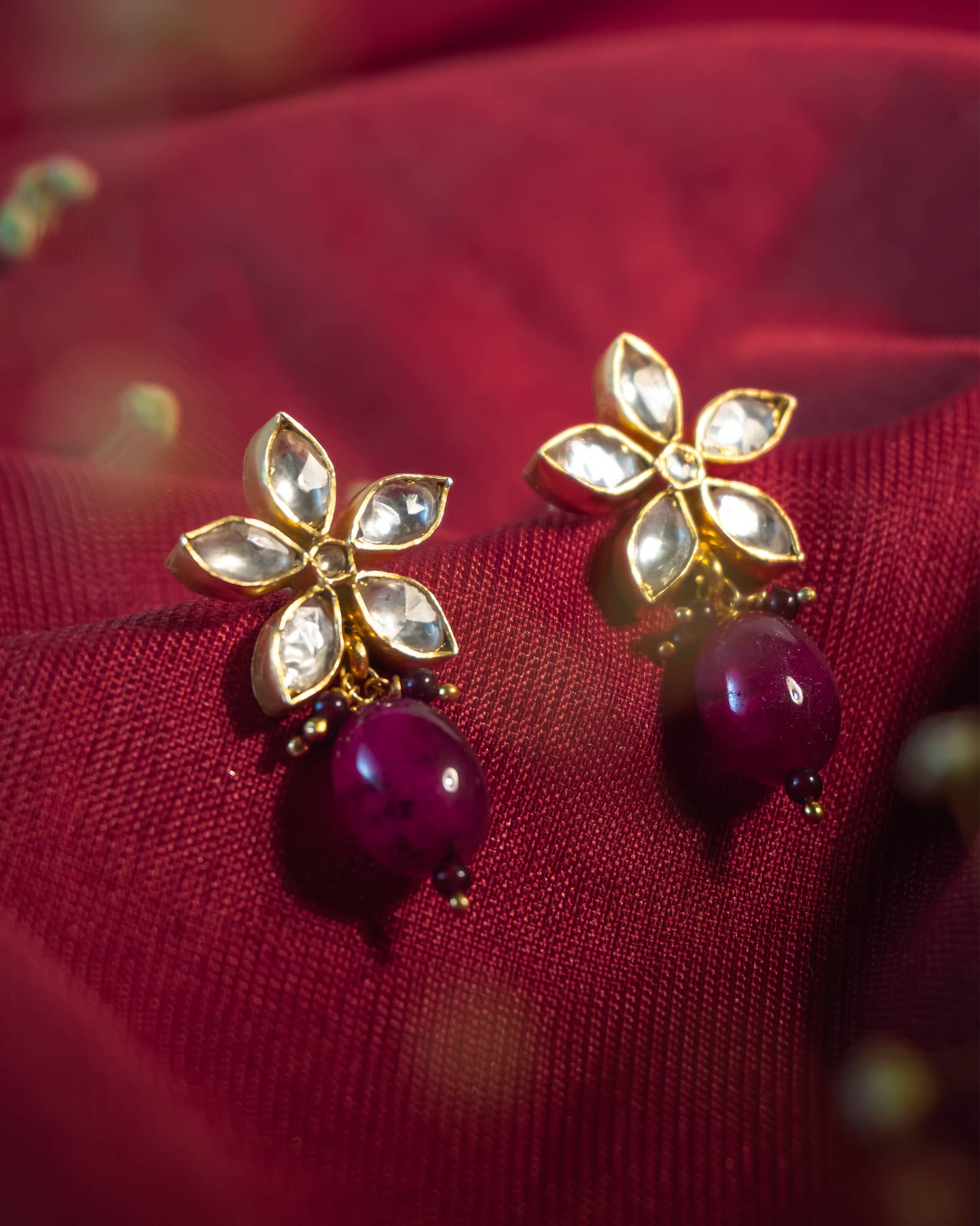 Gold plated 925 silver drop earrings featuring a polki flower stud and a smooth ruby pink bead drop.