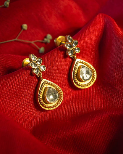 Gold plated drop earrings featuring a polki teardrop stone with rope texture border and floral stud.