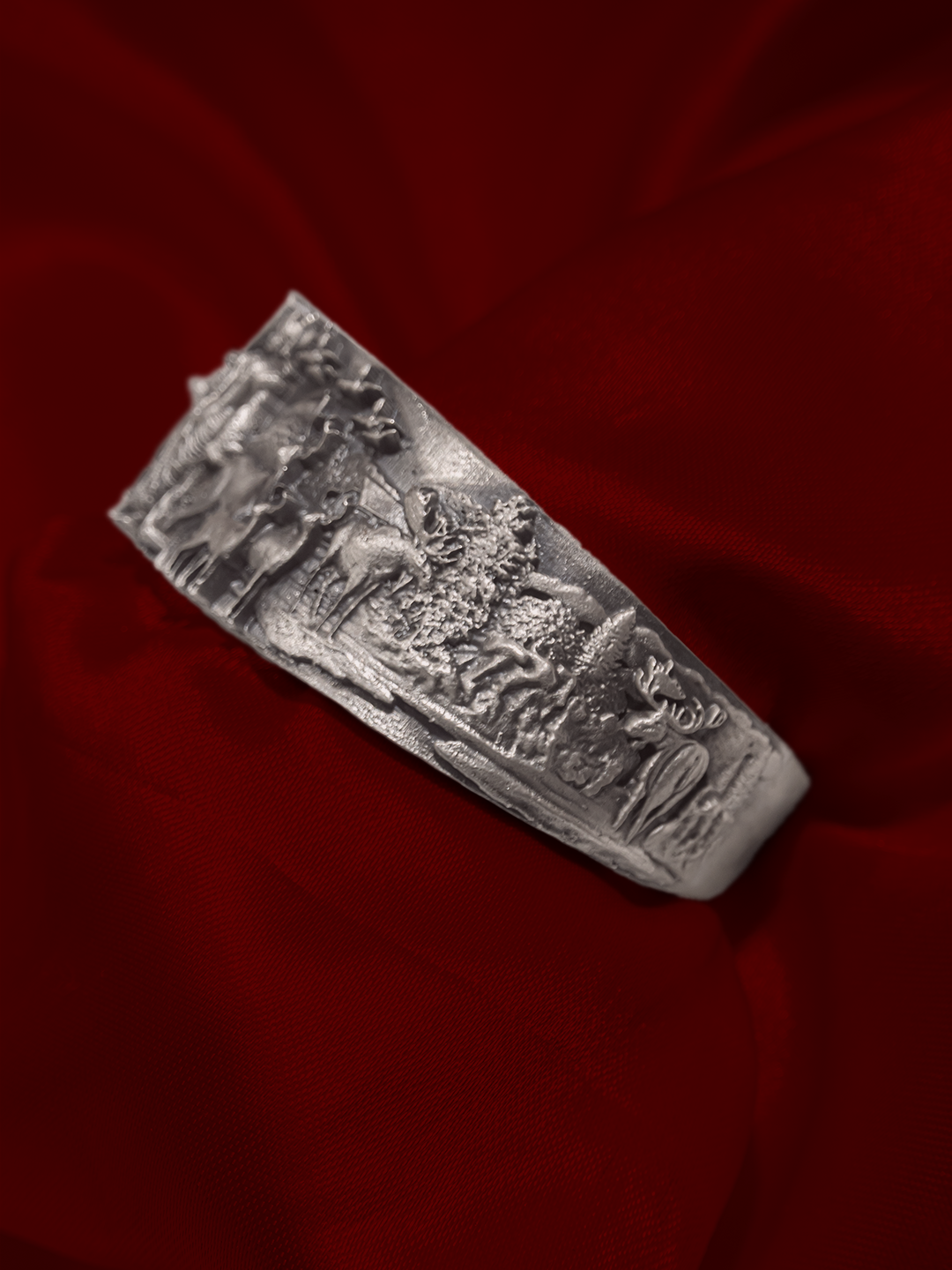 Broad silver temple kada for men close up of carved figures