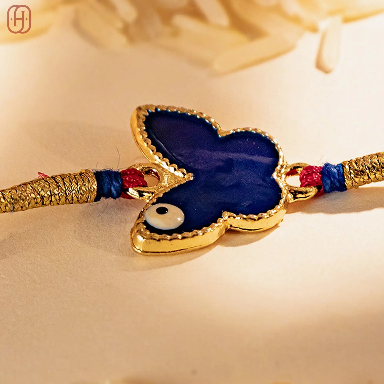 Hardik Jewels Butterfly Silver Rakhi with Blue Enamel.
